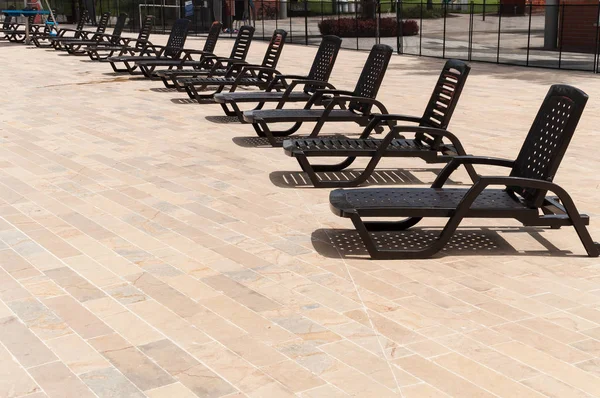 pool chairs by the pool on a sunny day