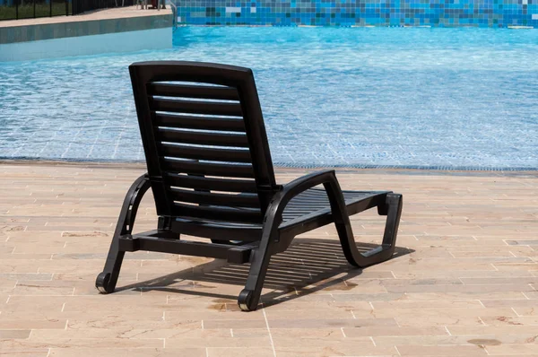 pool chair by the pool on a sunny day