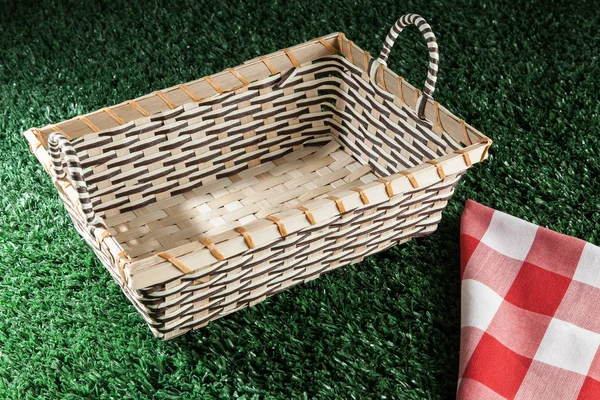 basket and picnic cloth on the meadow with copy space.