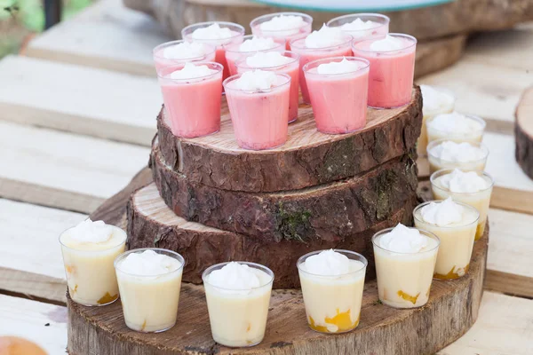 Tasty creamy mini desserts in cups ready for guests at the wedding reception.