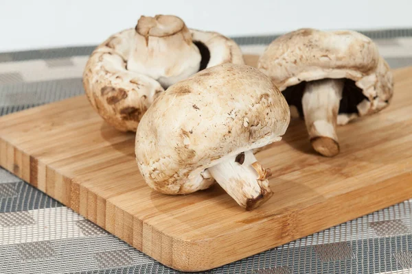 Mushrooms On Wooden Kitchen Chopping Board.