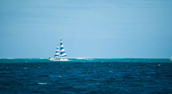 Uzak mavi gökyüzü ve sakin okyanus Hawaii mesafe içinde mavi ve beyaz yelken ile yat