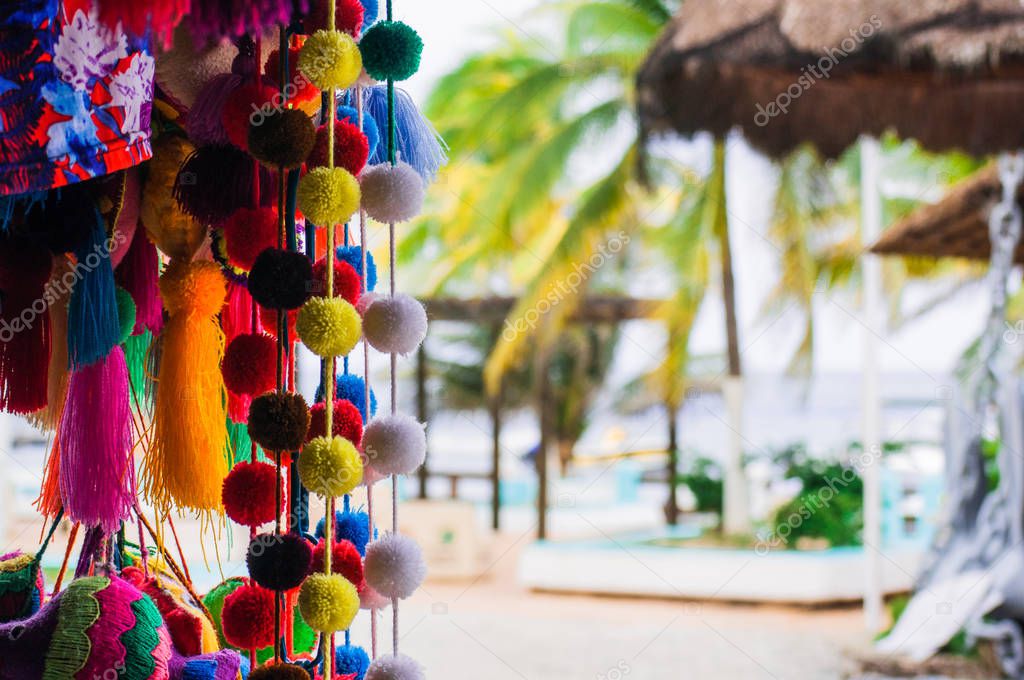 Handmade traditional Mexican souvenirs at the gift market in Puerto Morelos, Mexico, close up