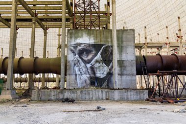 Doğu Avrupa, Ukrayna, Pripyat, Çernobil. 10 Nisan 2018. Bitmemiş soğutma kulesinin içinde, bir duvar resmi yorgun bir doktoru tasvir eder. Avustralyalı sanatçı Guido van Helton tarafından 2016 yılında Igor Kostin'in bir fotoğrafından uyarlanan bir resim. 