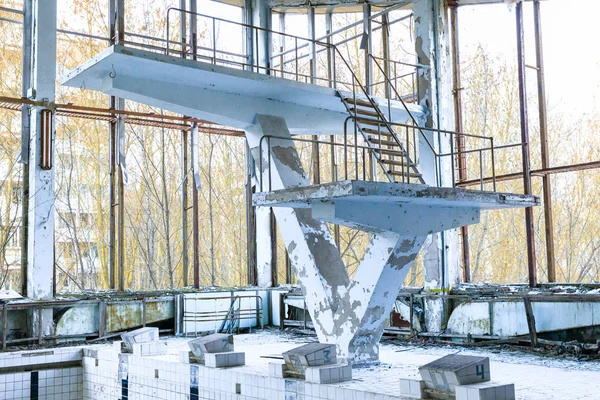 Eastern Europe, Ukraine, Pripyat, Chernobyl. Sports court, Azure swimming pool. Diving board. April 11, 2018.