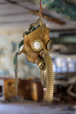 Eastern Europe, Ukraine, Pripyat, Chernobyl. Gas mask hanging from a wire. clipart