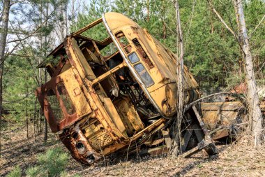 Eastern Europe, Ukraine, Pripyat, Chernobyl. Rusted overturned school bus. clipart