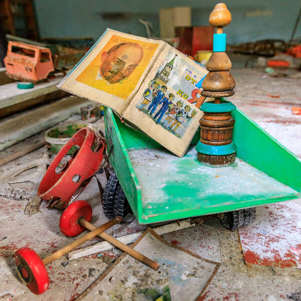 Eastern Europe, Ukraine, Pripyat, Chernobyl. Toys in the kindergarten. Children's book with picture of Lenin sits in a dumptruck. April 11, 2018.