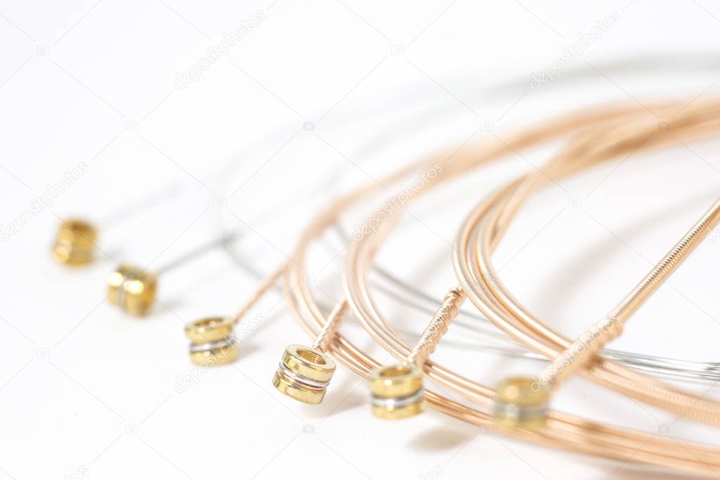 Set of twisted guitar strings isolated on white background