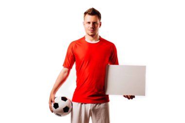 Young handsome football player soccer holds ball and white blank on white. clipart