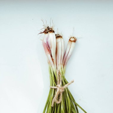 Beyaz arka plan üzerinde izole yeşil soğan. düz lay