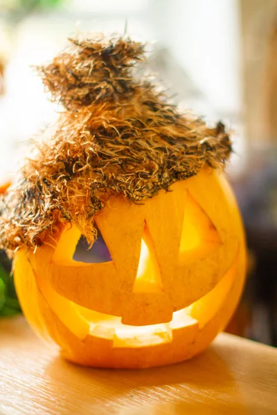 Bright scary pumpkin on a religious feast Halloween. Pumpkin on the table. Autumn tradition.