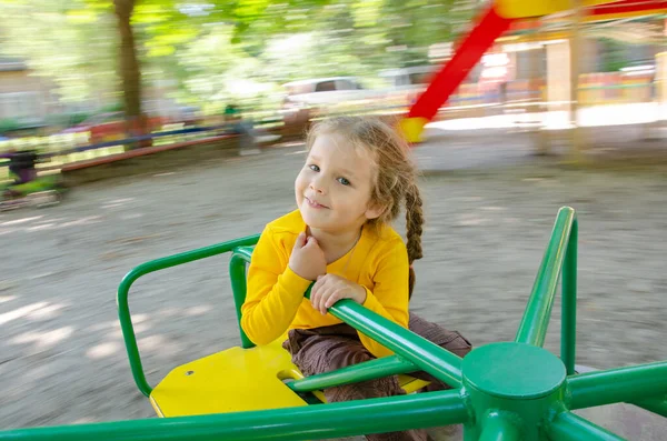 Beautiful Girl Yellow Shirt Playing Playground Child Riding Carousel Sense — Stock Photo, Image