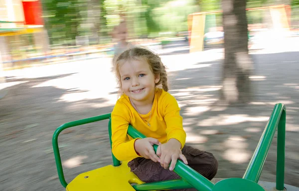 Beautiful Girl Yellow Shirt Playing Playground Child Riding Carousel Sense — Stock Photo, Image