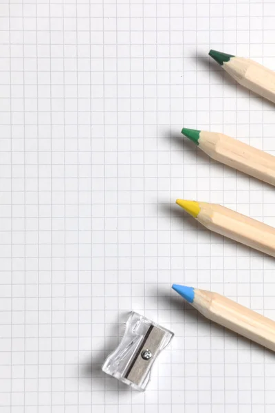Flache Lageansicht Von Weißem Notizbuch Farbstiften Und Bleistiftspitzer Auf Einem — Stockfoto