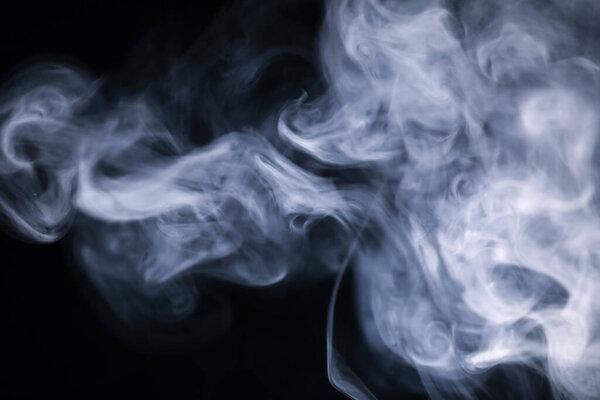 White cigarette smoke texture in a black background.