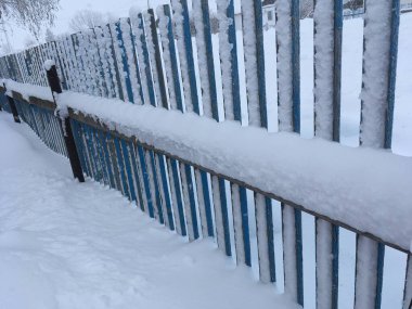 Mavi bir çitte kar ve buz