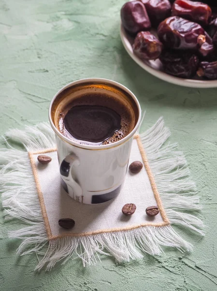 Black coffee and dates. Sweet food for Ramadan. — Stock Photo, Image