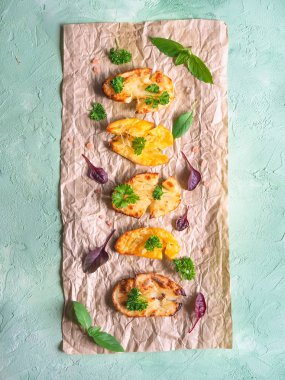 Parşömen üzerine gevrek maydanoz serpilir gevrek ezilmiş patates.