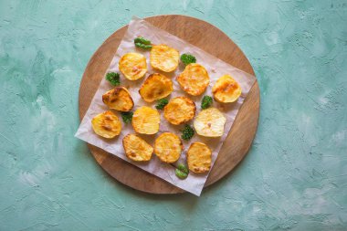 İştah açıcı fırında patates yarım parşömen üzerine.