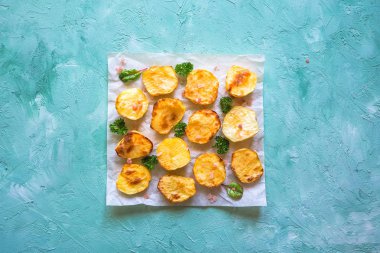 İştah açıcı fırında patates yarım parşömen üzerine.