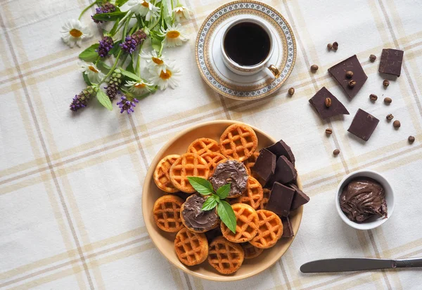 Round Belgian waffles with chocolate cream on a textile napkin. — Stock Photo, Image