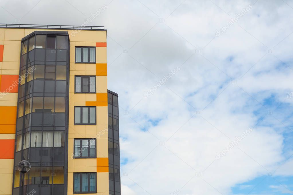 Modern beautiful new buildings. Colored wall on the background of blue sky.