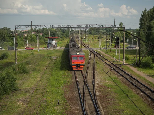 The train crosses the crossing in the countryside.