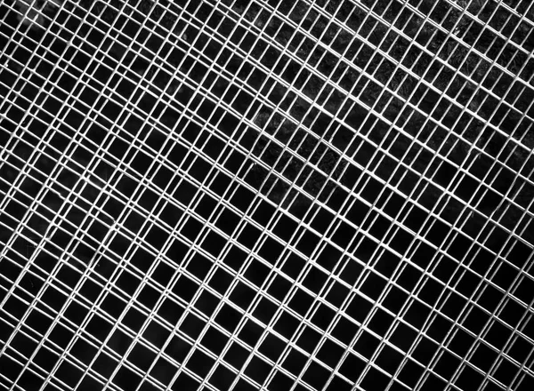 The texture of the silver mesh on a dark background. — Stock Photo, Image