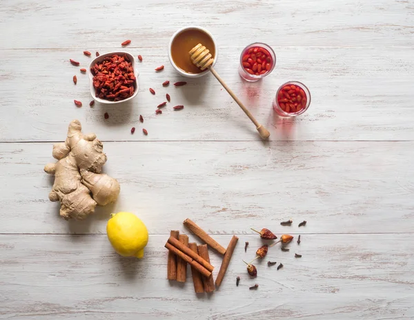 Ingrediënten voor thee met verse Goji bessen, citroen, honing en gember. — Stockfoto