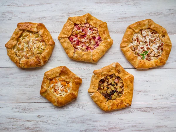 Pattern of different handmade pies on a white wooden table. — Stock Photo, Image