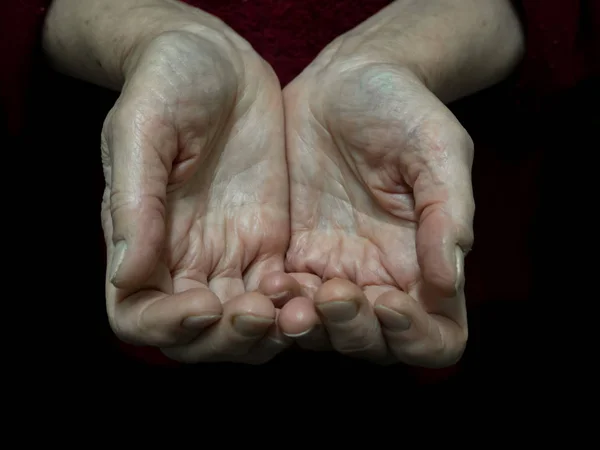 Begging alms by the hand of the pensioner.