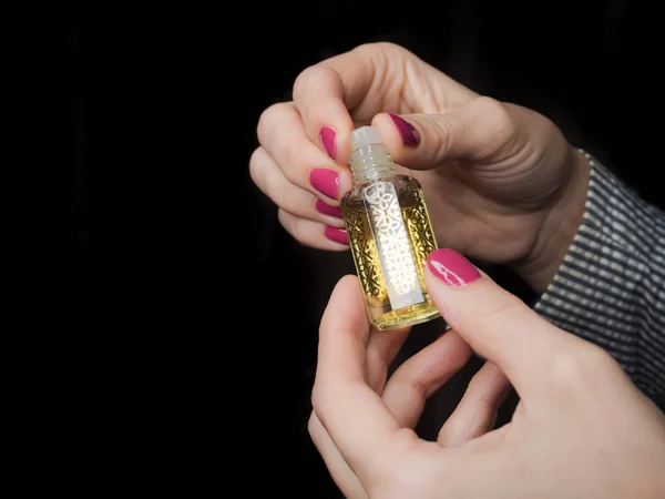 Europäische Hände einer Frau mit arabischem Parfümöl — Stockfoto
