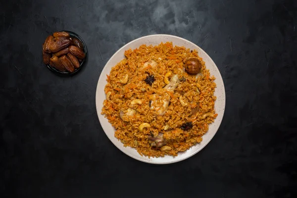 Chicken Kabsa with dates. Arabic dish. Top view.