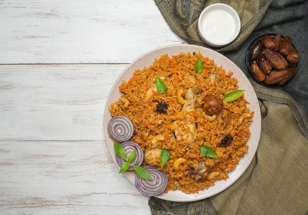 Chicken Kabsa with dates. Arabic dish. Top view.