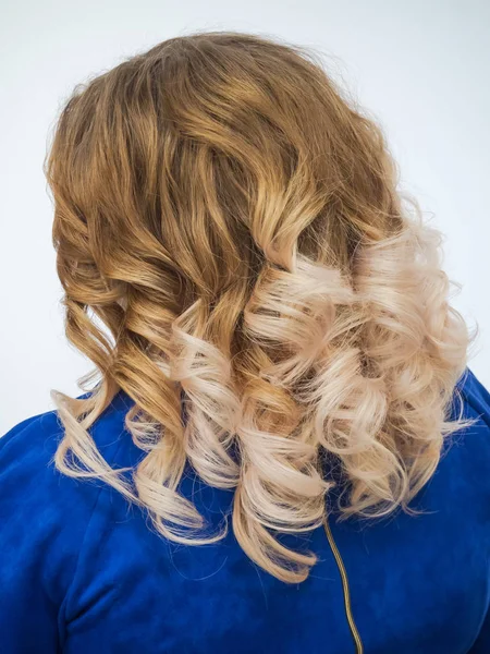 Gradient color on womens curly hair. Close up.