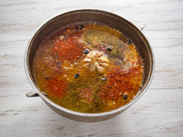 Cooking pilaf in a cauldron. Spices in pilaf. — Stock Image Cooking pilaf in a cauldron. Spices in pilaf. Royalty Free Stock Photos
