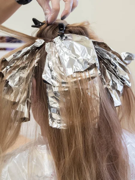 Foil on the hair when coloring the hair.
