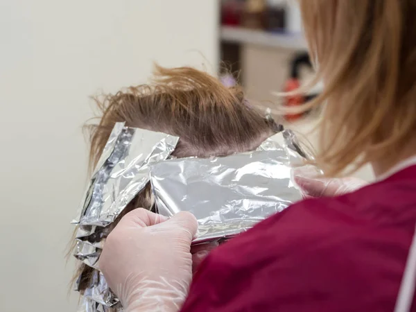 Foil on the hair when coloring the hair.