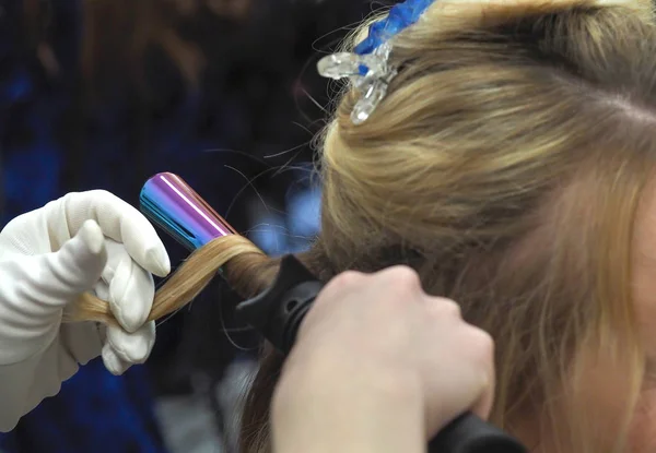 Hair on the Curling iron. Creating an hairstyle.