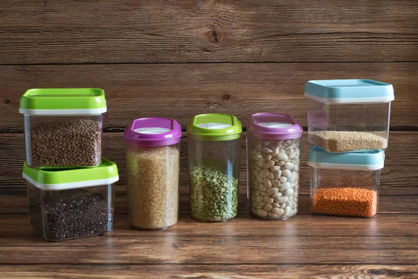 Cereales en recipientes de plástico sobre una mesa de madera . —  Fotos de Stock