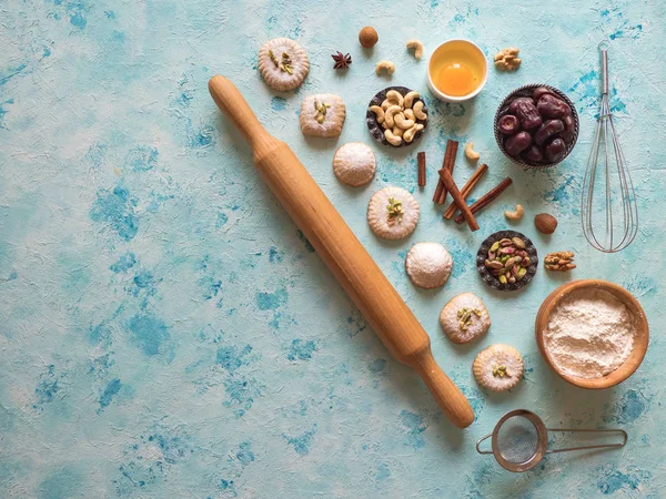 Sweets background. Egg, flour and nuts are laid out on a blue table