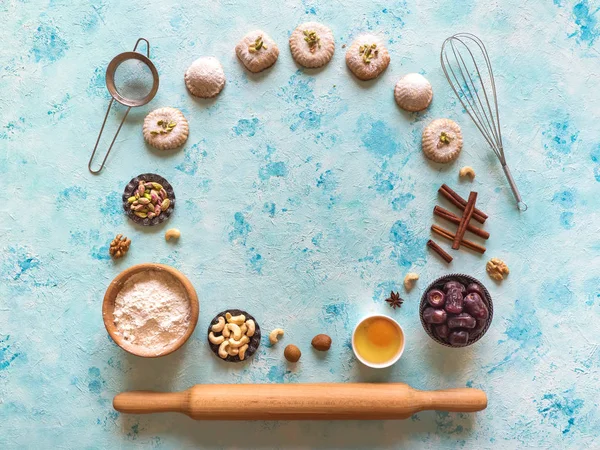 Sweets background. Egg, flour and nuts are laid out on a blue table
