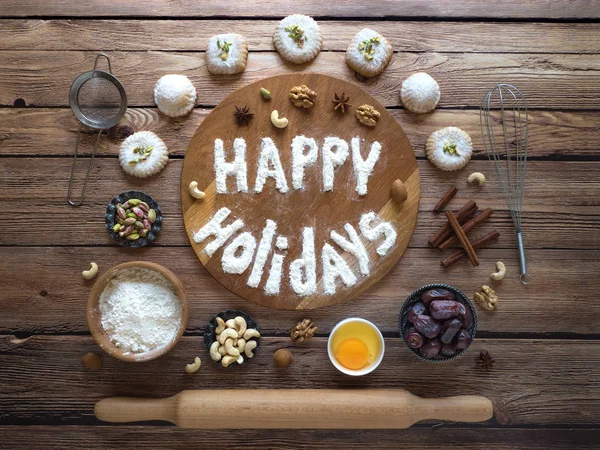Happy holidays food background. Egg, flour and nuts are laid out on a dark wooden background — Stock Photo, Image