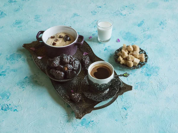 Breakfast with dates, coffee and healthy porridge on the blue table — Stock Photo, Image