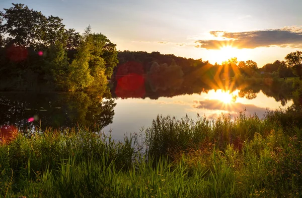 Prachtige zonsondergang op het meer met zonlicht. — Stockfoto