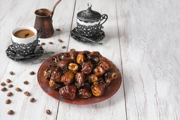 Organic sweet dates with syrup and black coffee.