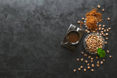Siyah arka plan üzerinde zemin tozu ile kahve ve kahve çekirdekleri Fincan, üst görünümü