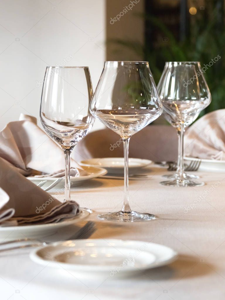 Empty wine glasses are served on the table