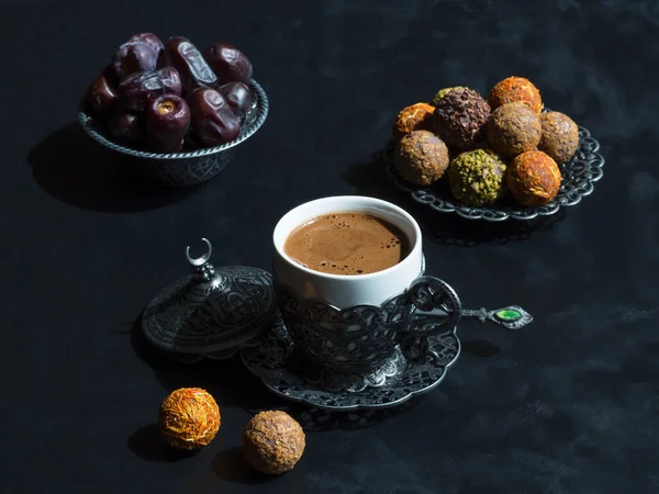A cup of Turkish coffee with Arabic sweets with dates on a blue table — Stock Photo, Image